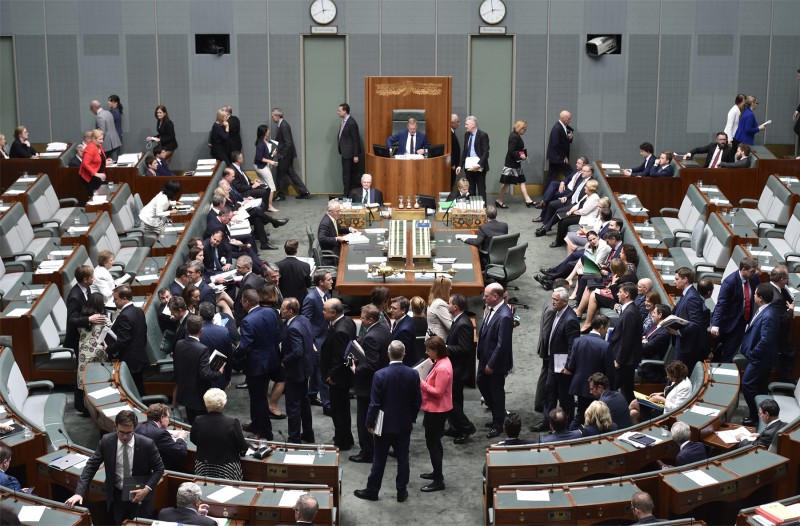 The green House of Representatives. There are people milling around.